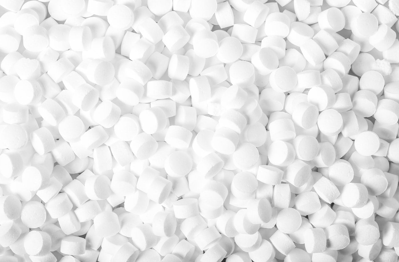 Clean white pharmaceutical tablets representing compounded medication