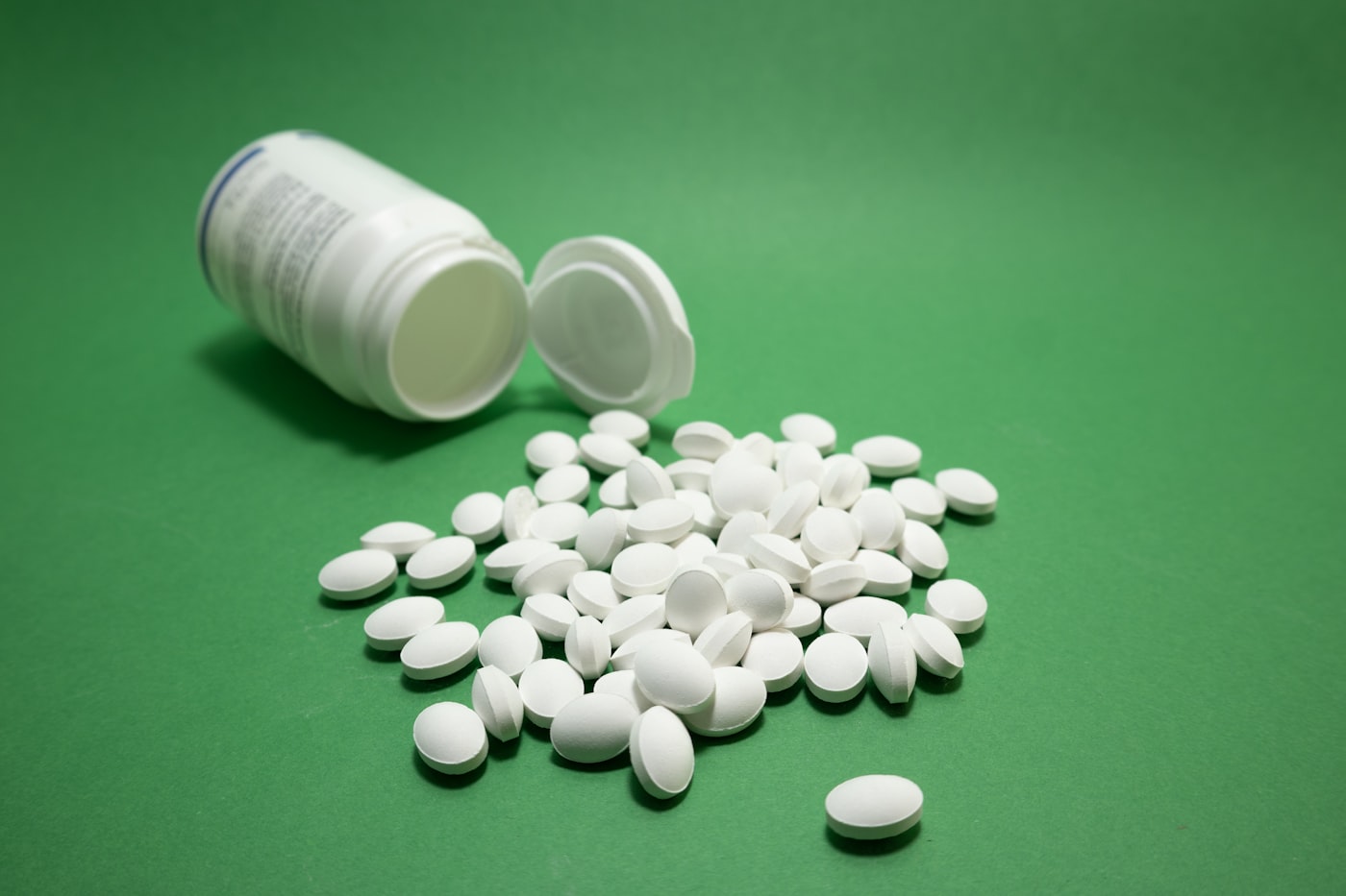 Pharmaceutical pills with bottle on a neutral background